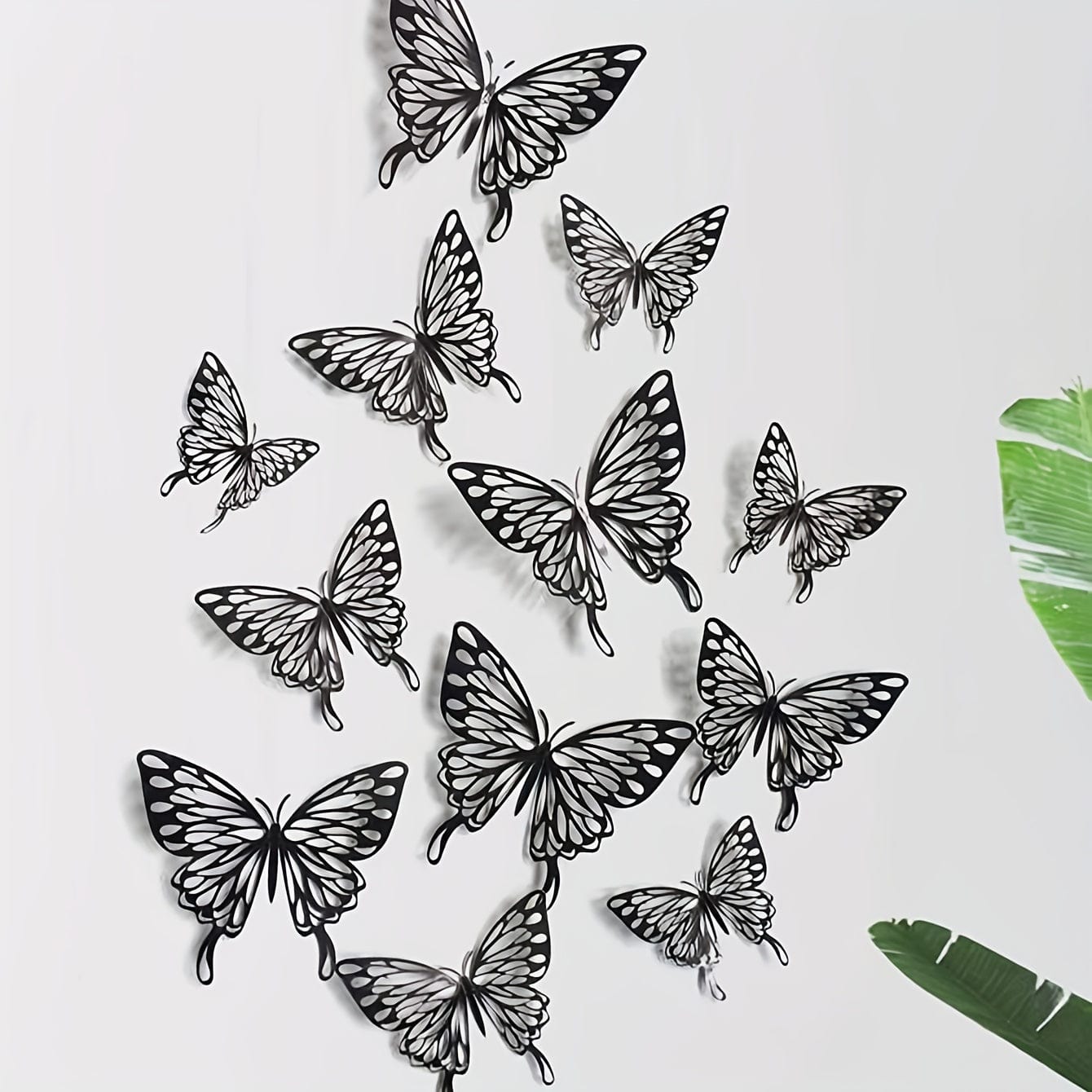 Black butterflies on white wall