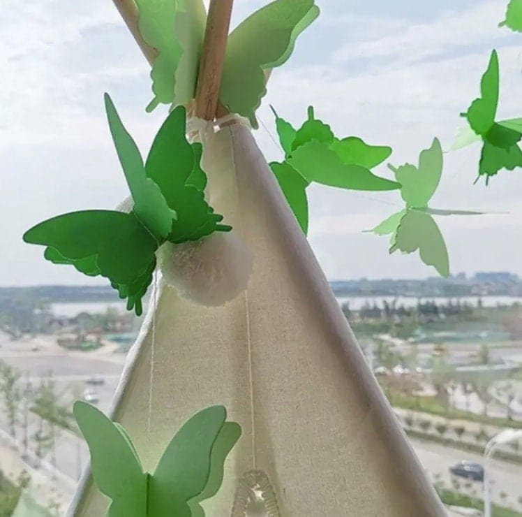 Green colored butterflies on a string