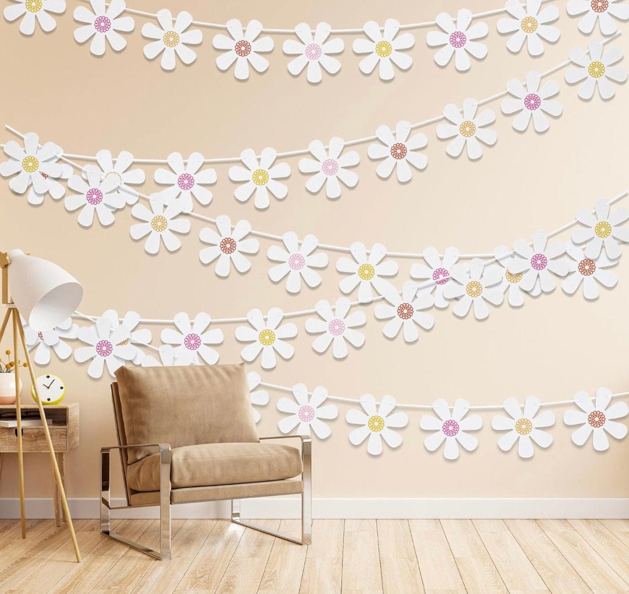 daisy banner hanging on wall with chair and light under white daisy garland 